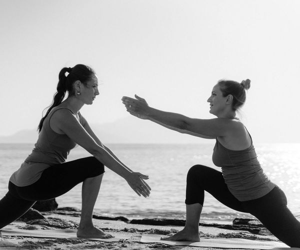 Person stretching outdoors during a beautiful sunrise.